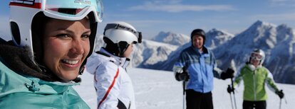 4 Skifahrer stehen auf Skipiste