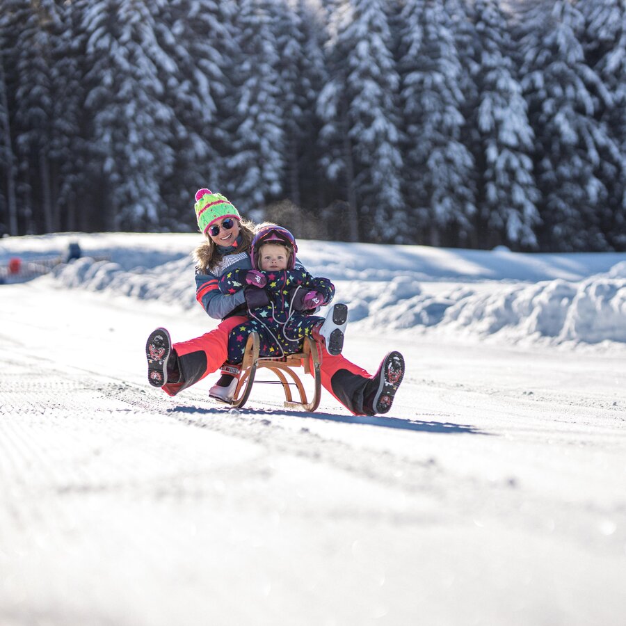 Mother and child on a toboggan