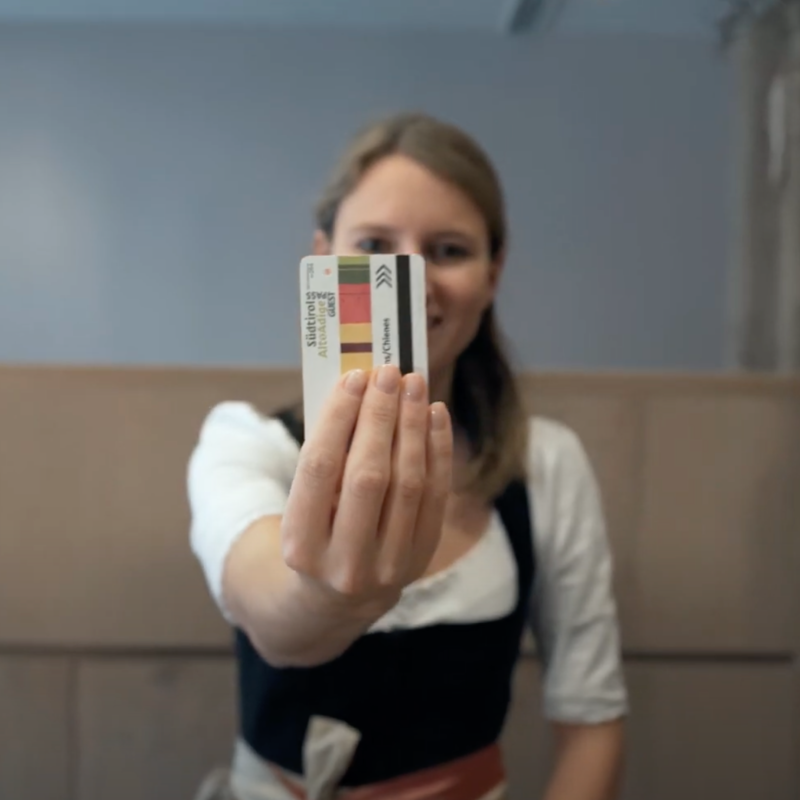 Young woman holding a Holiday Pass